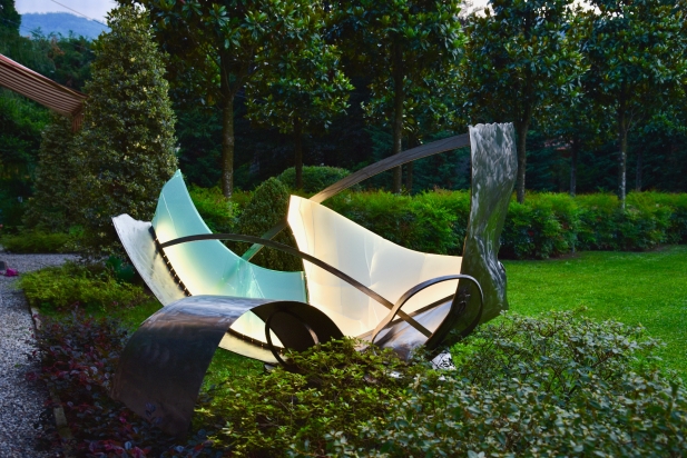 <b>Following gusts of wind</b> |  2017. Exterior light sculpture. Made from recycled stainless steel and multilayer glass, lighting LED.
240 x 120 x 220 cm. Private Park Bellagio (Lake Como) Italy.