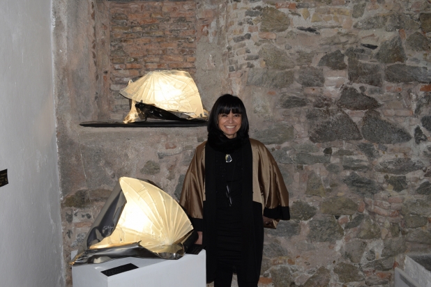 The Artist Franca Franchi next to two light sculptures